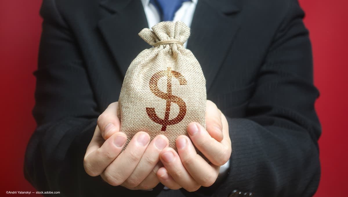 a man wearing a suit holding a bag of money (Image Credit: AdobeStock)