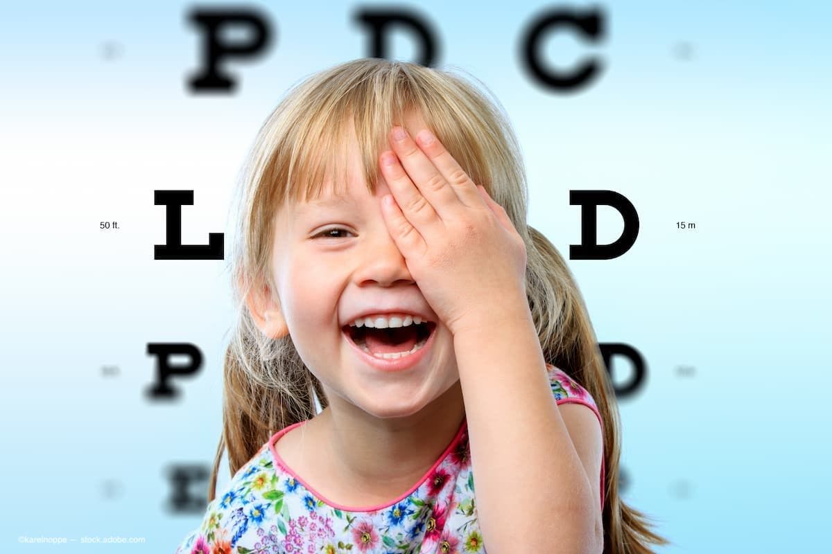 A smiling child taking an eye test (Image Credit: AdobeStock/karelnoppe)