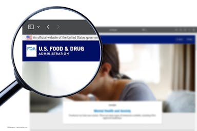 A magnifying glass enlarges the US FDA logo on the FDA website. Image credit: ©Oleksandr – stock.adobe.com