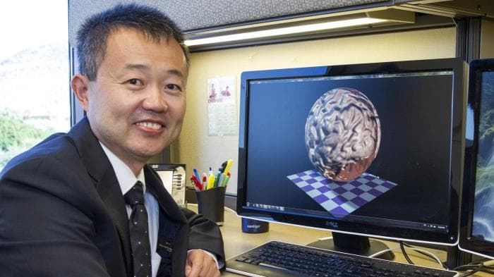 Yalin Wang, PhD, is shown at work in his office. The researcher in the School of Computing and Augmented Intelligence and his team have published a series of papers that outline their research. (Image credit: Nora Skrodenis/ASU)